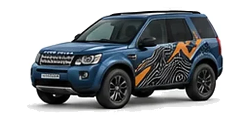 Land Rover Freelander in Tasman Blue with mountain and contour-inspired vinyl side graphics, front three-quarter view on a white background.