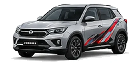 SsangYong Korando in Silent Silver with red, white and black angular vinyl side graphics, front three-quarter view on a white background.
