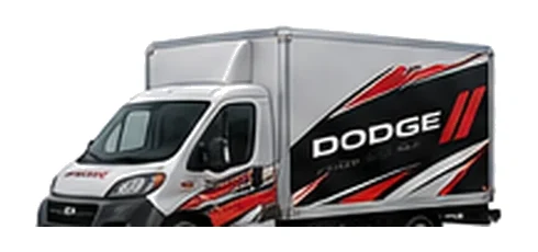 Dodge ProMaster Cutaway in silver with custom van vinyl graphics, front three-quarter view.
