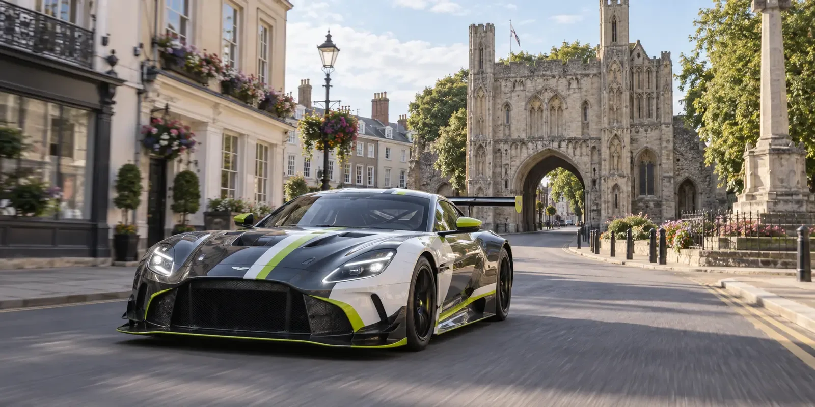Race-liveried GT car travelling past the Abbey Gate in Bury St Edmunds