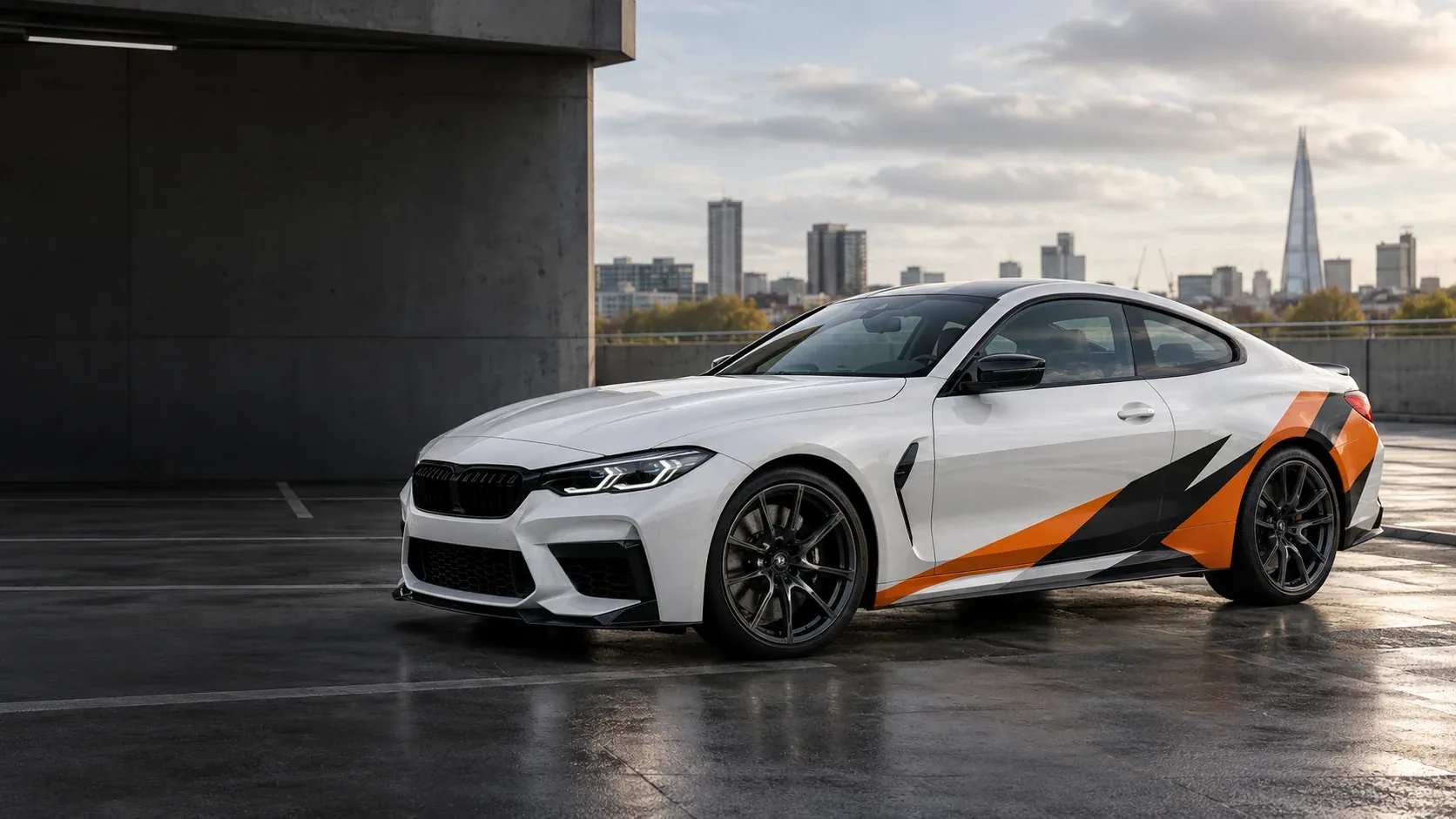 Partial car wrap concept with orange and black lower-door and rear-quarter graphics on a white coupe